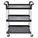A black Cambro utility cart with three shelves and wheels.