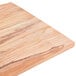 An American Metalcraft olive wood serving board on a table.
