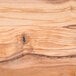 A close up of the wood grain on an American Metalcraft olive wood serving board.