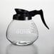 A Bunn glass coffee decanter with a black handle.