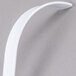 A white plastic curved ladle with a white handle.