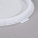 A translucent plastic Cambro lid with text on it.