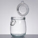 An American Metalcraft glass apothecary jar with a hinged metal lid.