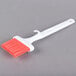 A white Carlisle Sparta pastry brush with red silicone bristles.