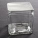 An American Metalcraft square PET jar lid on a glass container.