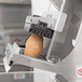 A potato being processed in an Edlund Titan Max-Cut Manual 3/8" Dicer.