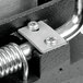A close-up of a metal bracket with screws.