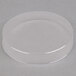 A clear plastic round lid over a white surface.