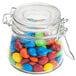 An American Metalcraft miniature hinged apothecary jar filled with colorful candy.