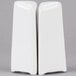 Two white porcelain triangle salt and pepper shakers.