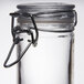 An American Metalcraft miniature glass apothecary jar with a metal hinged lid and hook.