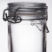 An American Metalcraft miniature glass apothecary jar with a hinged lid.