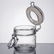 An American Metalcraft glass miniature apothecary jar with a metal lid and ring open.
