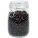 An American Metalcraft glass hinged apothecary jar filled with black pepper seeds.