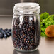 An American Metalcraft glass hinged apothecary jar filled with blueberries.