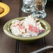 A bowl of crab sticks and mayonnaise in a GET Diamond Harvest avocado melamine bowl.