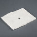 A square white insulation pad with a square hole in the center.
