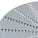 A circular metal Waring shredder plate with holes in it.