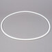 A white plastic circle on a grey surface.