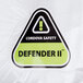 Cordova white disposable microporous coveralls with a green and black triangle sign.