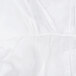 A close-up of a white microporous coverall with a white background.