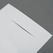 A white piece of paper with a cut out in it.