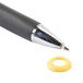 A black pen next to a yellow circle shaped object.