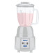 A Waring blender with pink liquid in it.