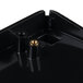 A black plastic surface with gold screws.