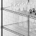 A Regency shelf with white vases and glasses on a white surface with a close-up of a white PVC shelf liner.