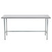 An Advance Tabco stainless steel work table with a metal frame and legs.