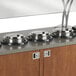 A row of Vollrath silver drop-in induction rethermalizers on a hotel buffet counter.