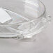 A close-up of a clear plastic container with a white chopping lid.