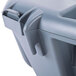 A close-up of a grey plastic San Jamar Saf-T-Wrap container with a handle and lid.