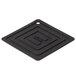 A black square shaped Lodge silicone pot holder on a table in a home kitchen.