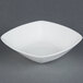A white square CAC bowl on a gray surface.