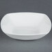 A CAC MAJ-B6 white square bowl on a grey surface.
