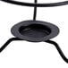 A black metal stand for a round black pan with a hole in the bottom.