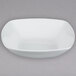 A CAC MAJ-B9 white square bowl with a small rim on a gray surface.