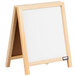 A white tabletop A-frame sign with a wooden frame and white marker board.