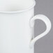 A close-up of a white CAC Majesty European bone china mug with a handle.