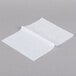 Durable Packaging BT-8 Interfolded Bakery Tissue Sheets folded on a gray surface