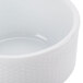 A close up of a CAC Boston Super Bright White Stacking Porcelain Nappie Bowl with an embossed design.