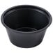 A Dart black plastic souffle bowl with a white background.