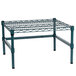 A green epoxy coated metal wire rack with black support legs.