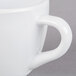 A white melamine espresso cup with a handle.