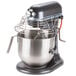 A KitchenAid dark gray commercial mixer with a metal bowl and stand.