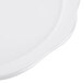 A white round melamine display platter with a scalloped edge.