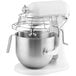 A white KitchenAid bowl lift mixer with a metal bowl.
