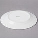 A CAC Harmony super white porcelain plate with green text that says "CAE"